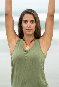 yoga model wearing gong necklace at beach