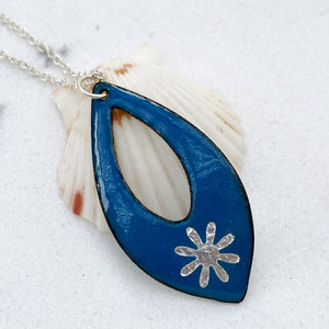 blue enamel silver snowflake necklace with silver chain on shell